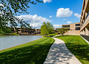 Thumbnail 72 of 112 - A pathway runs alongside a body of water. at The Residences at Tesson Ridge Apartments, Saint Louis, MO, 63128