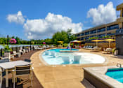 Thumbnail 68 of 112 - A large outdoor pool area with a hot tub and lounge chairs at The Residences at Tesson Ridge Apartments, Saint Louis, Missouri