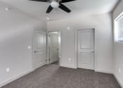 Thumbnail 36 of 54 - an empty room with three doors and a ceiling fan