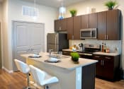 Thumbnail 17 of 17 - Kitchen with wooden cabinets at The Villages of Twin Oaks, Twin Oaks, MO