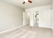 Thumbnail 15 of 31 - a bedroom with two doors and a ceiling fan