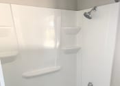 Thumbnail 24 of 37 - a white bathroom with a shower and a tub