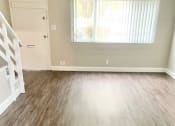 Thumbnail 31 of 37 - an empty living room with a wooden floor