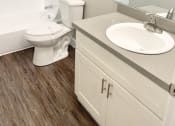 Thumbnail 33 of 37 - a bathroom with a toilet and a sink and a mirror