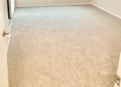 Thumbnail 29 of 37 - an empty room with a window and a carpeted floor