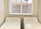 Thumbnail 37 of 37 - two washers and a window in a small laundry room