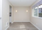Thumbnail 3 of 17 - a bedroom with hardwood flooring and a large window