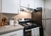 Thumbnail 1 of 31 - a kitchen with white cabinets and stainless steel appliances