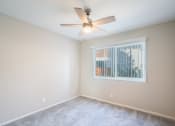 Thumbnail 10 of 31 - a bedroom with a ceiling fan and a window