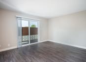 Thumbnail 11 of 31 - a bedroom with a sliding glass door and hardwood floors