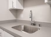 Thumbnail 9 of 31 - a kitchen sink with a faucet in a 555 waverly unit