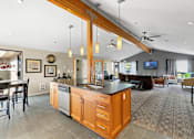Thumbnail 2 of 27 - A modern kitchen with wooden cabinets and a large island.