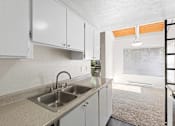 Thumbnail 12 of 27 - A kitchen with white cabinets and a stainless steel sink.