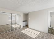 Thumbnail 14 of 27 - A room with a carpeted floor and a glass door.