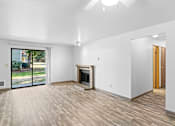 Thumbnail 22 of 27 - A room with a fireplace and sliding glass doors.