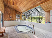 Thumbnail 10 of 27 - A wooden ceiling over a hot tub in a room.