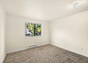 Thumbnail 13 of 27 - A room with a window and a carpeted floor.
