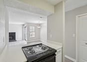 Thumbnail 29 of 40 - A black stove top oven in a white kitchen.