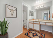 Thumbnail 17 of 26 - A bathroom with a cow skull on the wall.