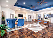 Thumbnail 8 of 28 - A living room with a brown floor and a ceiling fan.