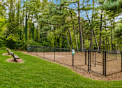 Thumbnail 36 of 40 - A baseball field is surrounded by a fence and trees.