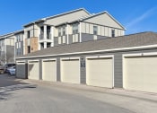 Thumbnail 26 of 27 - a garage with multiple doors in front of a house