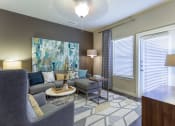 Thumbnail 6 of 27 - Model Living Room with Ceiling Fan and Patio/Balcony Entry