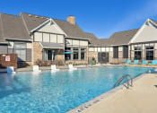 Thumbnail 22 of 27 - the preserve at ballantyne commons pool and building with lounge chairs