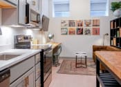 Thumbnail 17 of 22 - Kitchen bar island in 1st floor studio apartment at Myers Medical Lofts