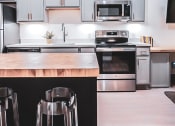 Thumbnail 16 of 22 - kitchen bar island in 1st floor studio apartment at Myers Medical Lofts