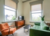 Thumbnail 6 of 22 - living room and 2 large windows looking out of 3rd floor unit at Myers Medical Lofts