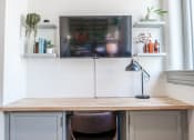 Thumbnail 12 of 22 - built-in desk and wall mounted TV in apartment at Myers Medical Lofts