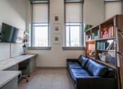 Thumbnail 13 of 22 - living room area with 2 large windows in apartment at Myers Medical Lofts