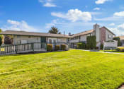 Thumbnail 7 of 7 - a view of a yard in front of some apartments