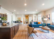 Thumbnail 2 of 19 - image of the clubhouse with a kitchen and a blue couch and island