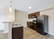 Thumbnail 15 of 19 - a kitchen with a refrigerator and a sink