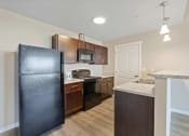Thumbnail 10 of 19 - a kitchen with a refrigerator and a stove and