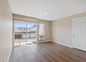 Thumbnail 14 of 19 - an empty living room with a door to a balcony