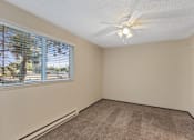 Thumbnail 4 of 5 - A room with a window and a ceiling fan.