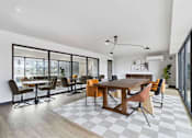 Thumbnail 8 of 18 - A modern dining room with a large table and chairs.