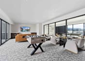 Thumbnail 11 of 18 - A room with a pool table and chairs.