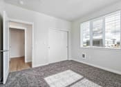 Thumbnail 16 of 18 - A room with a large rug in the middle of the floor.