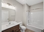 Thumbnail 12 of 13 - a bathroom with a shower toilet and sink and a mirror