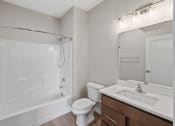 Thumbnail 5 of 13 - a bathroom with a shower toilet and sink and a mirror