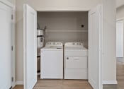 Thumbnail 7 of 13 - an empty laundry room with washer and a dryer
