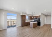 Thumbnail 3 of 13 - a spacious living room with a kitchen and a balcony