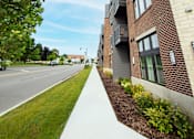 Thumbnail 46 of 48 - an apartment building with a sign on the side of the street