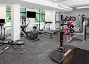 Thumbnail 28 of 48 - a gym with cardio machines and other exercise equipment in a building