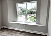 Thumbnail 8 of 34 - A room with a window overlooking a street.