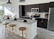 Thumbnail 1 of 48 - a kitchen with a large island with three stools